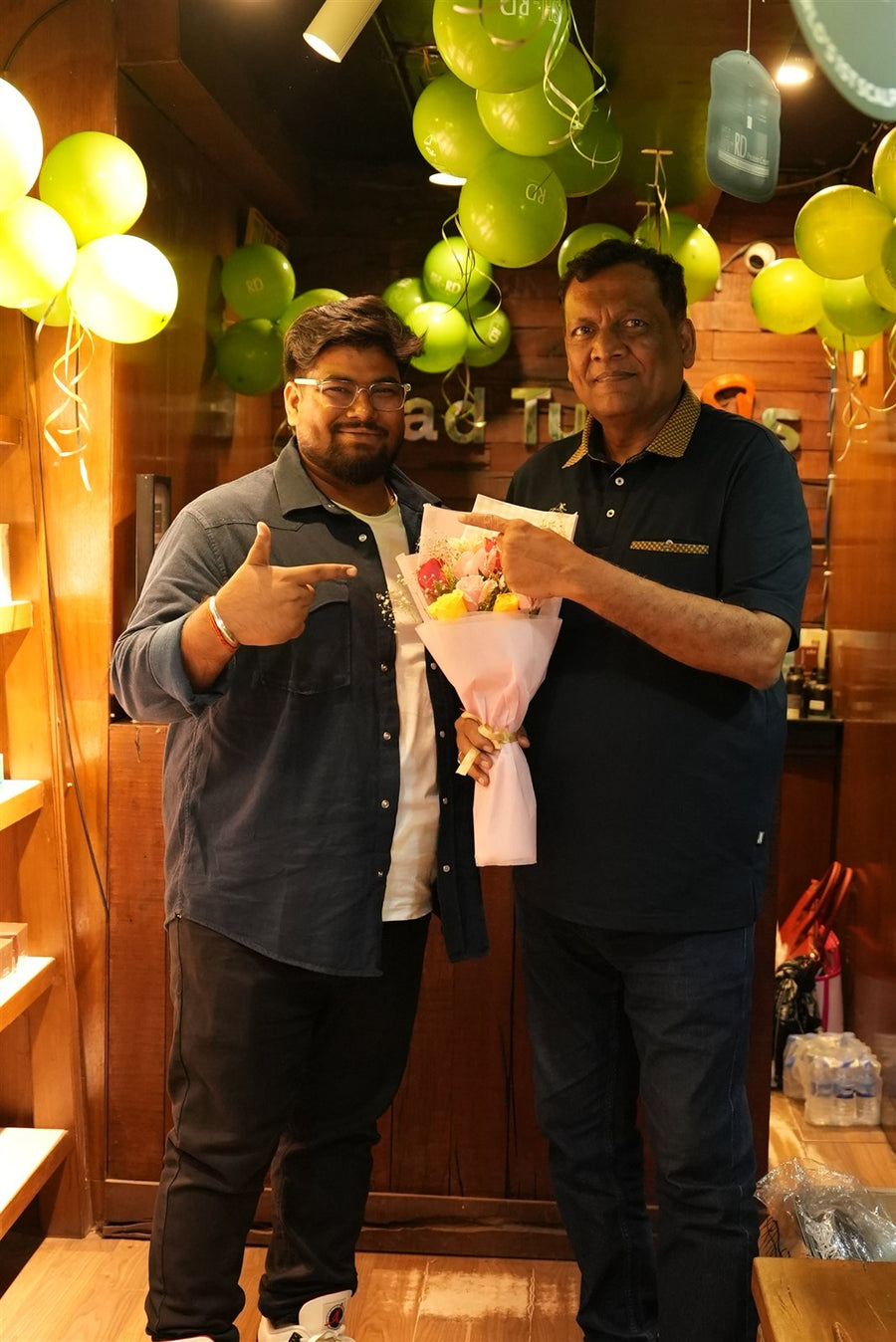 Two men with a bouquet at Avani Riverside Mall