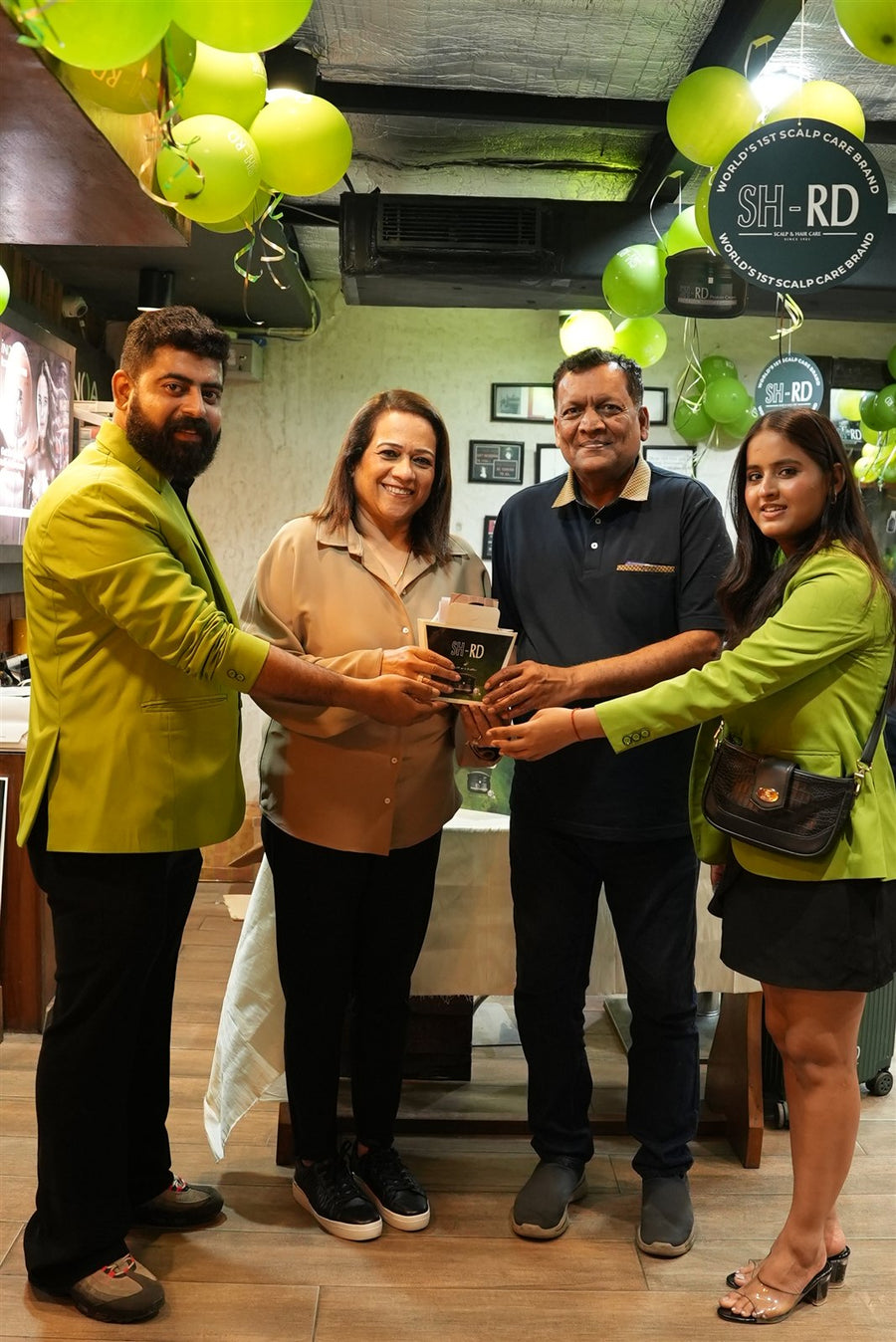 Team members and guests holding a commemorative plaque at Avani Riverside Mall