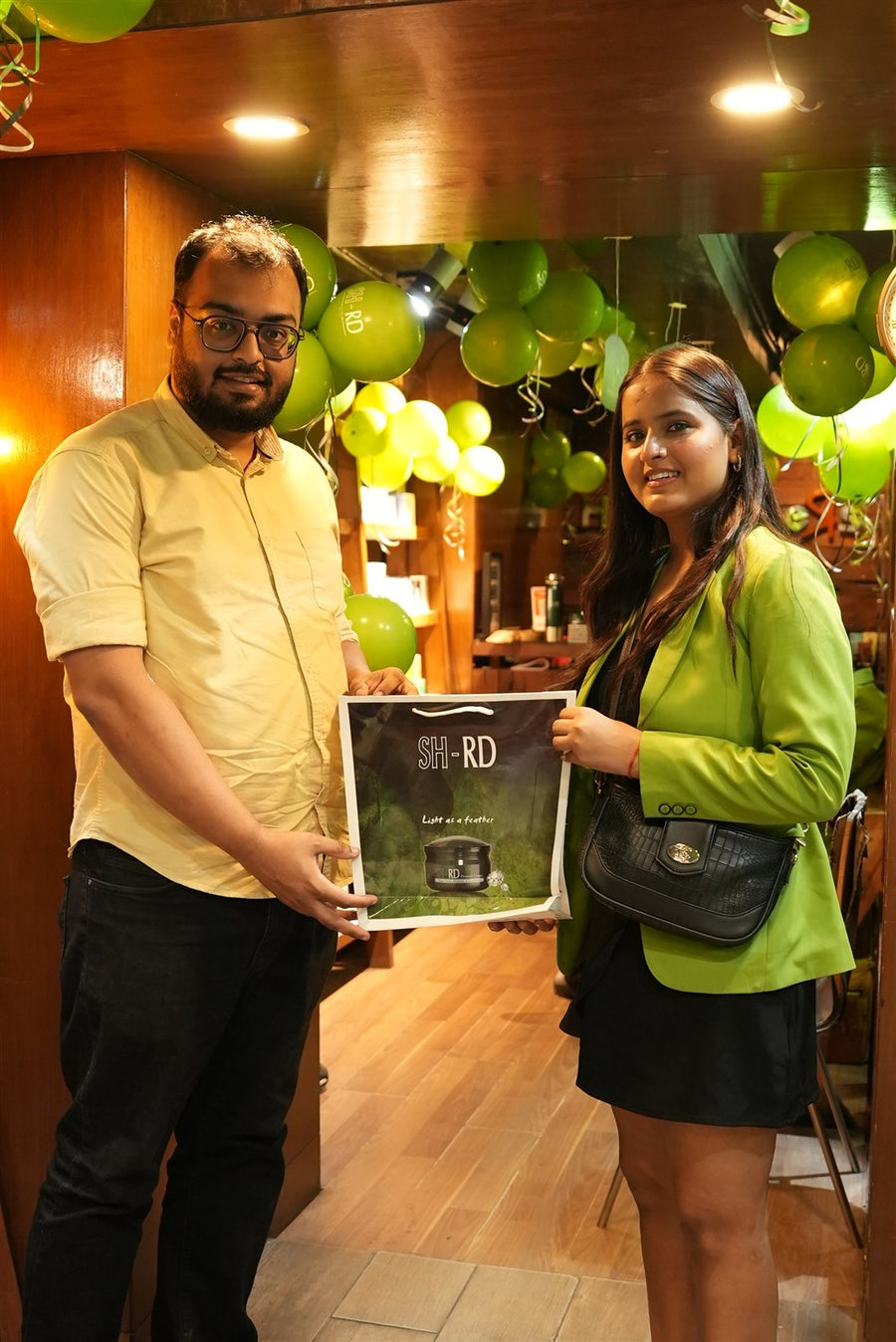A guest receiving an SH-RD framed gift at Avani Riverside Mall